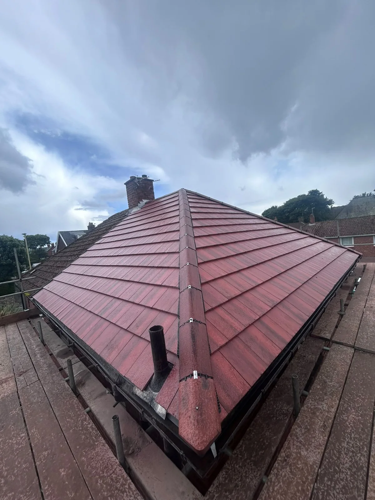 New red concrete tile hip roof with a dry hip junction